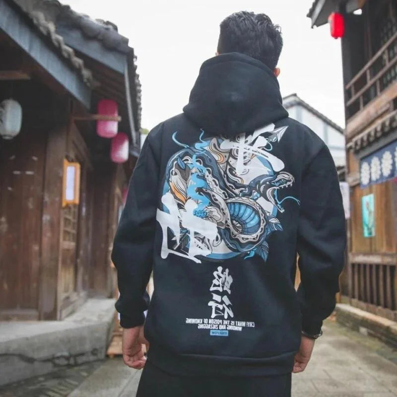 man wearing black hoodie with dragon