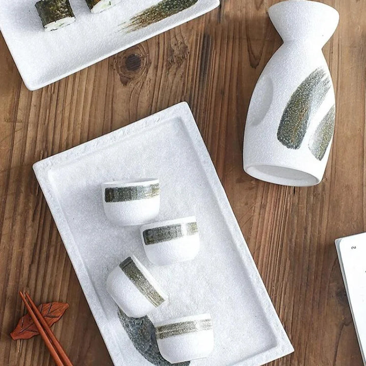 sake bottle and cup set on a table