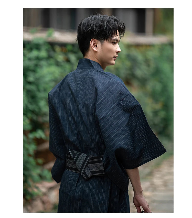 man wearing dark blue kimono