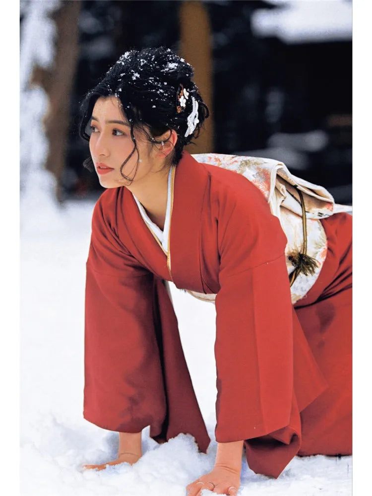 japanese girl in snow with a red silk kimono