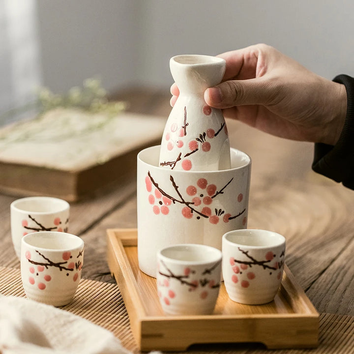 holding a sake set cherry blossom