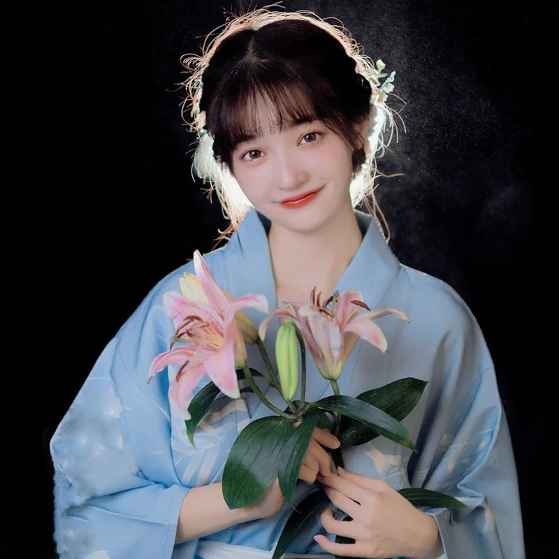 girl with flowers wearing blue satin kimono robe