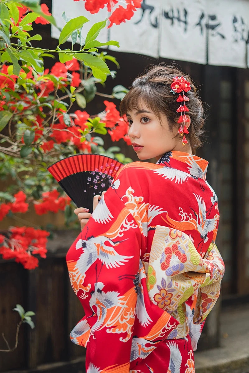 woman with a japanese fan wearing a kimono crane