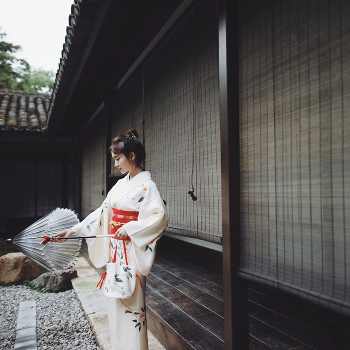 woman with an umbrella outside wearing white linen kimono