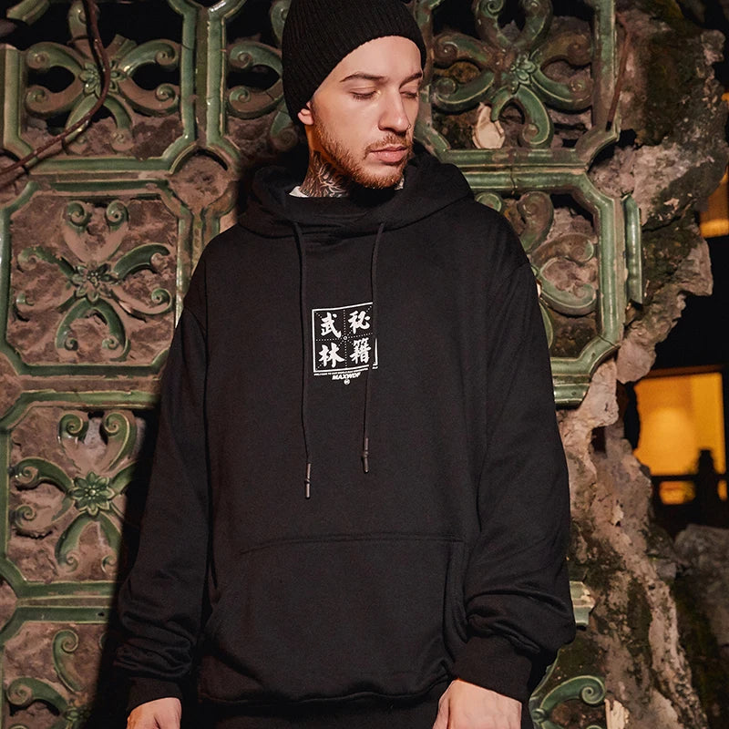 man wearing black hoodie japanese writing