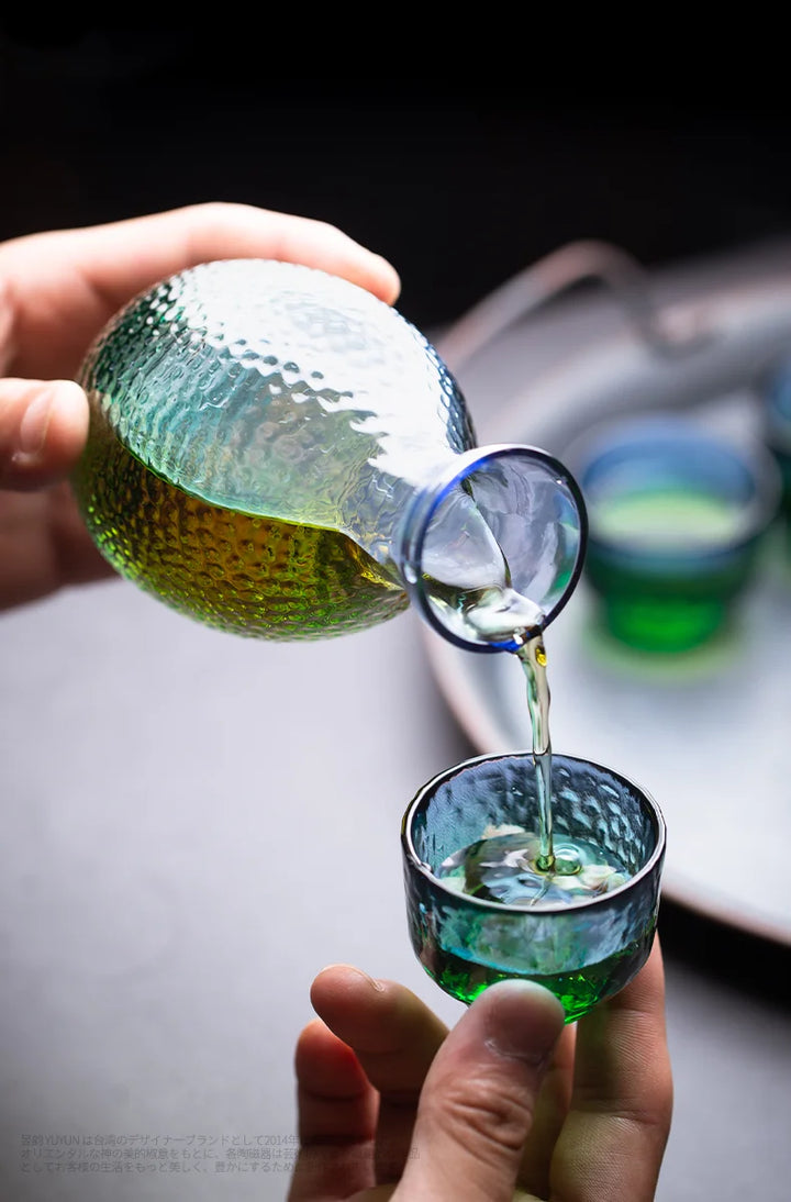 putting sake inside a glass cold sake set