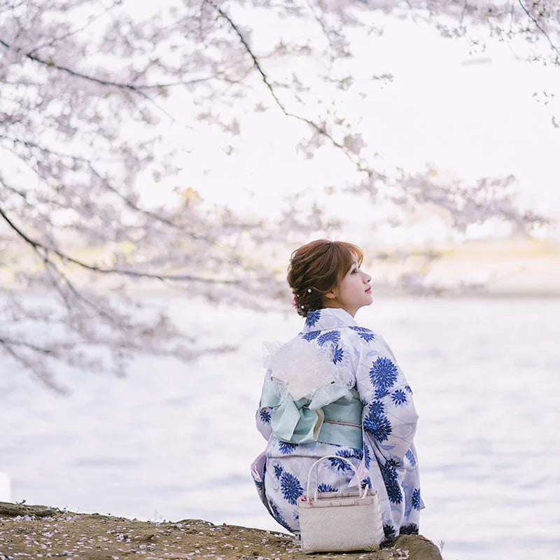 sitted woman wearing japanese kimono blue and white