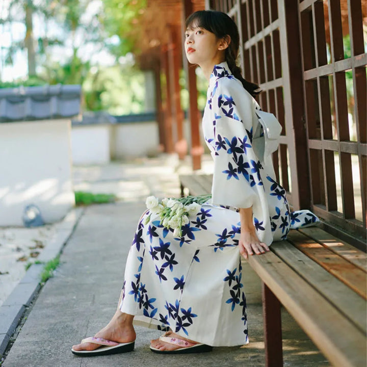 sitted woman with a blue and white kimono