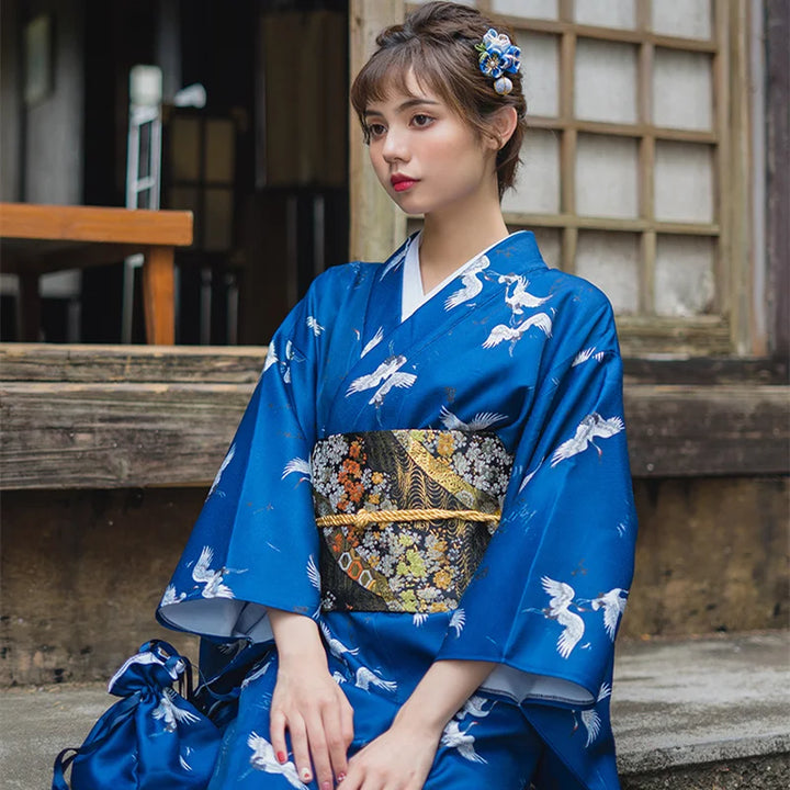 sitted woman wearing kimono with cranes