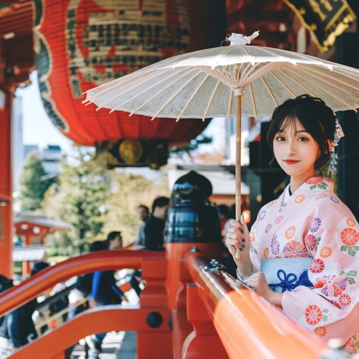 woman with an umbrella wearing pink kimono