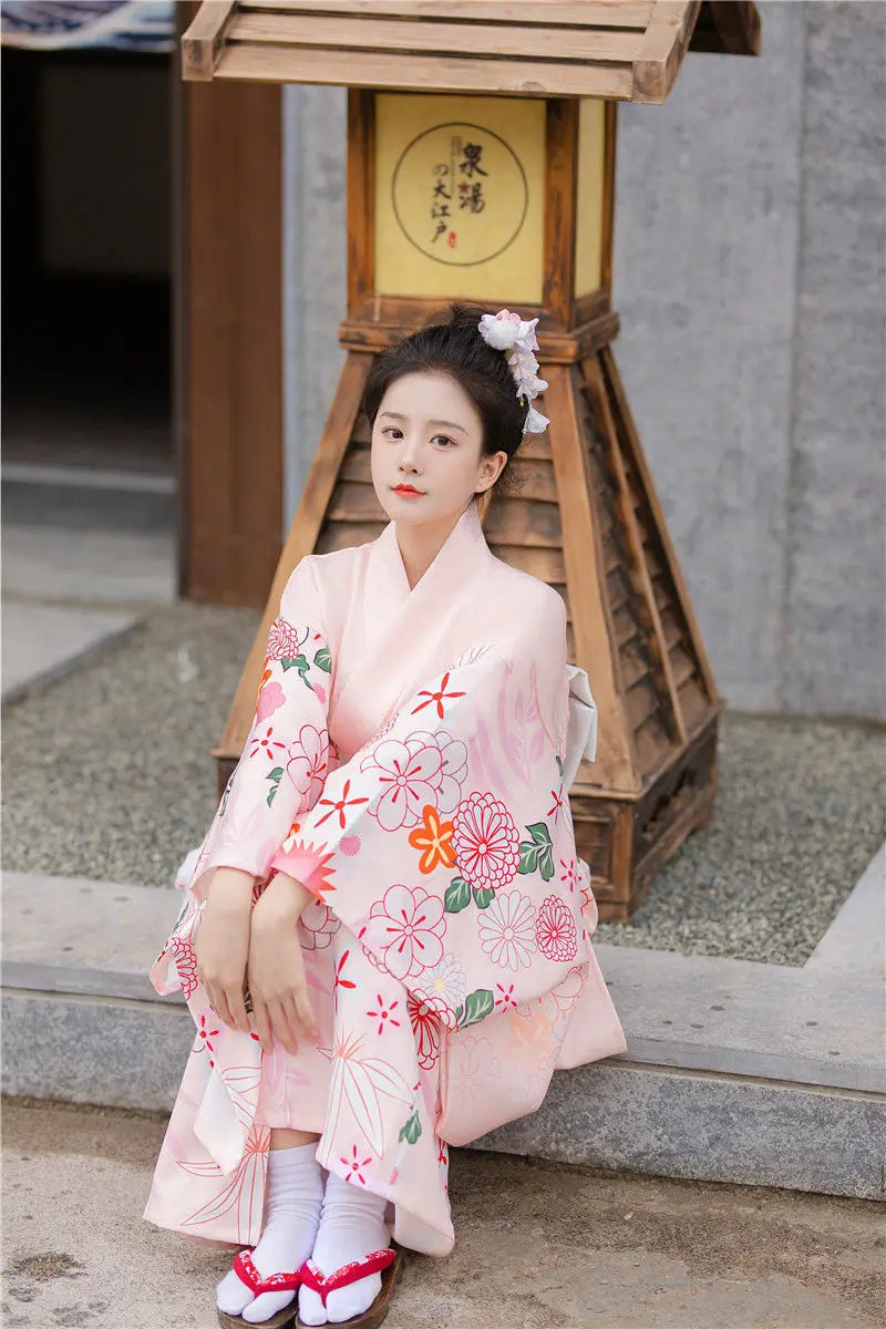 sitted woman wearing pink floral kimono