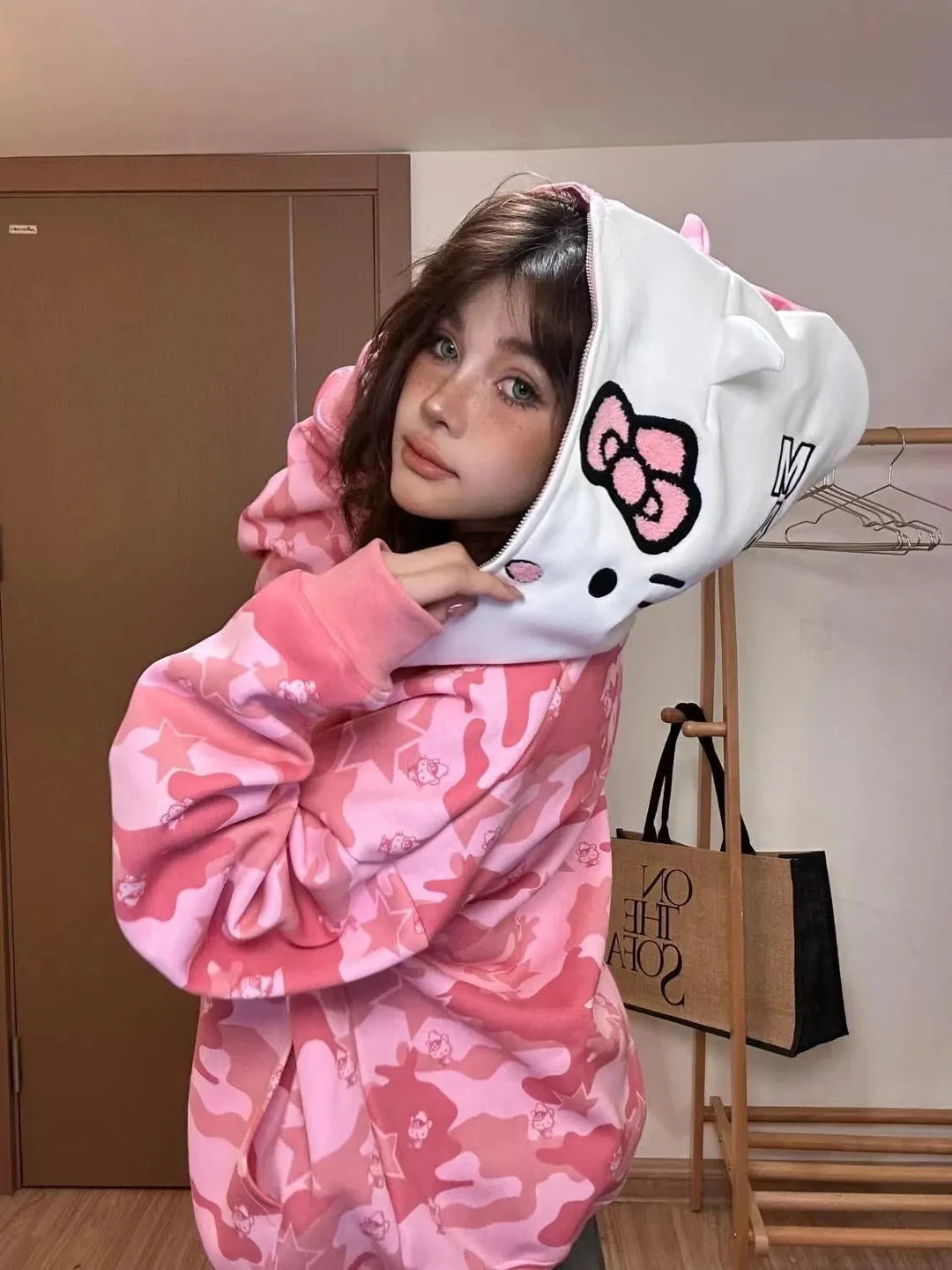 cute girl with a pink hello kitty bape hoodie