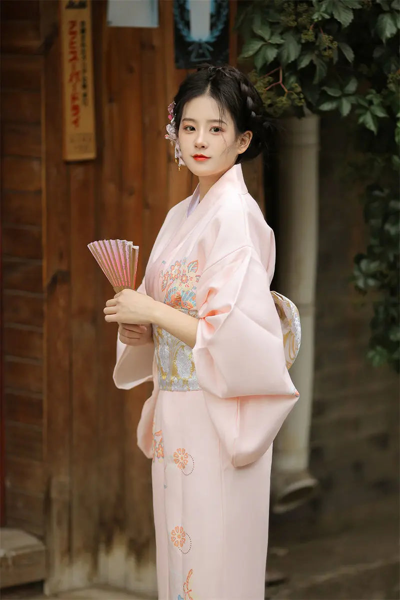 happy japanese girl wearing light pink kimono