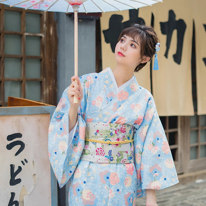 woman with an umbrella wearing blue kimono robe