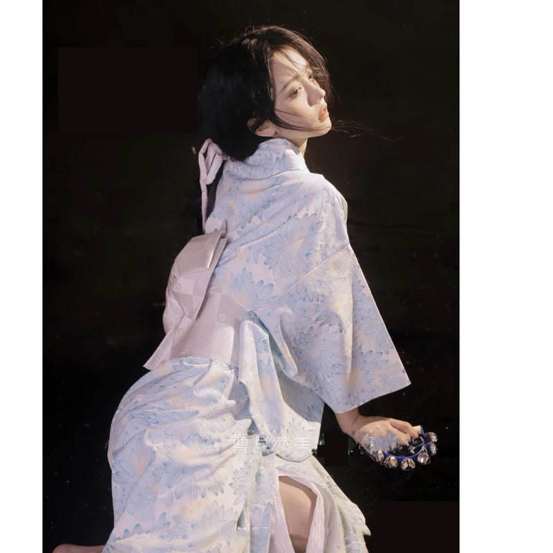 shy woman wearing blue floral kimono robe