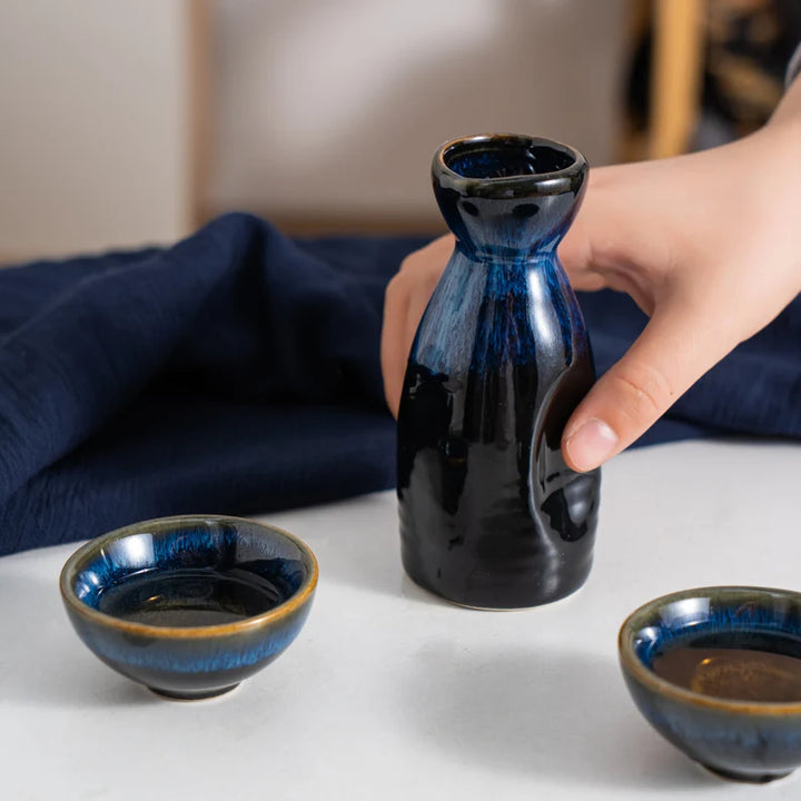 holding the bottle of a antique sake set