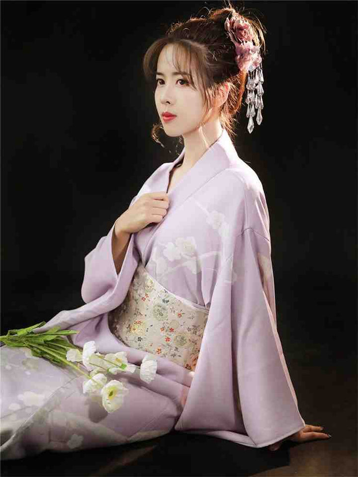 sitted shy woman with a purple kimono robe