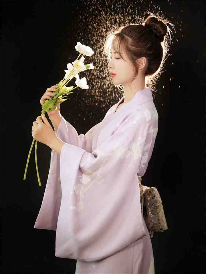 woman with flowers wearing purple kimono robe